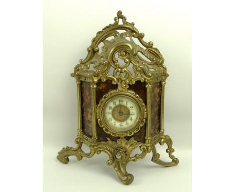 A Victorian gilt metal and faux tortoiseshell mantel clock, the circular face with Arabic numerals, by The British United Clo