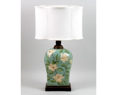 A modern table lamp, of squared baluster form, decorated in with pink flowers against an eau de nil ground, with cream shade,