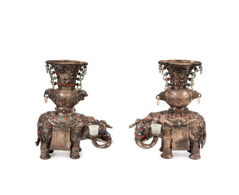 The pair of silver elephant ornaments adorned with turquoise, coral, and jade decorations. The tusks are crafted from jade, a