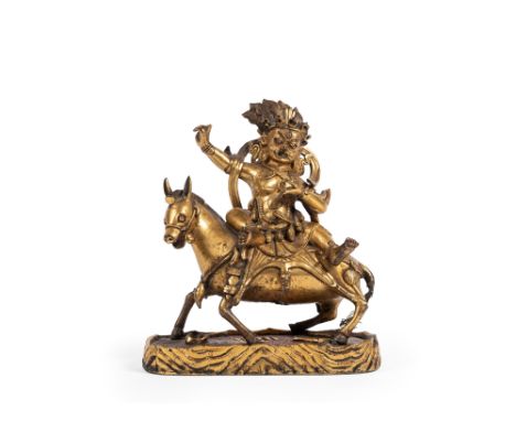 Depicted with a wrathful expression, seated in lalitasana on a mule. The right arm is raised, while the left hand like holdin