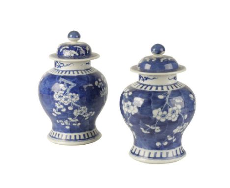 TWO BLUE AND WHITE COVERED JARS, LATE QING DYNASTY, the baluster sides painted with prunus, apocryphal Kangxi marks, 27cm hig