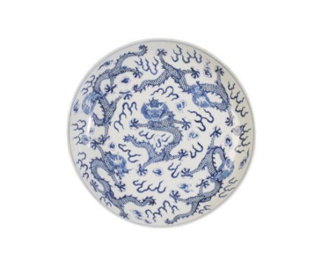 BLUE AND WHITE 'DRAGON' DISH, QING DYNASTY, 19TH CENTURY, painted in tones of underglaze blue with five dragon chasing flamin