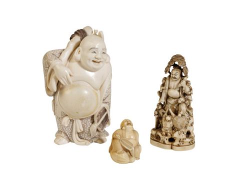 CARVED IVORY FIGURE OF A LAUGHING BUDDHA, MEIJI PERIOD, modelled as him carrying a large sack which he supports on a tree bra