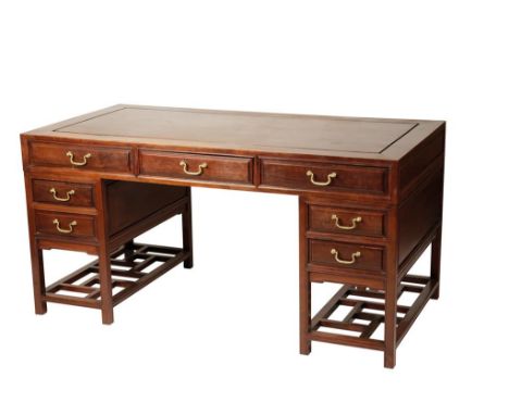 CHINESE HARDWOOD PEDESTAL DESK with a rectangular Huanghuali top over three frieze drawers, each pedestal with two drawers ov