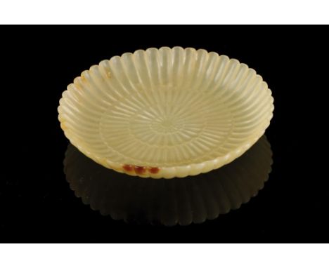 YELLOW JADE CHRYSANTHEMUM DISH, carved with four rows of radiating fluted petals resembling a chrysanthemum flower, 11cm diam