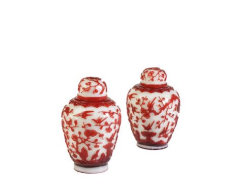 PAIR OF RUBY-RED OVERLAY WHITE GLASS 'CRAB APPLE AND PRUNUS' COVERED JARS, LATE QING DYNASTY, the baluster sides carved throu