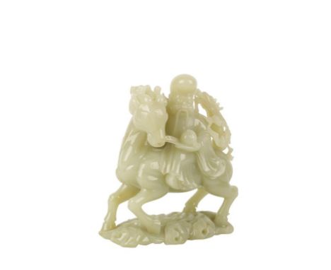 CELADON AND RUSSET JADE CARVED GROUP, modelled as Shoulao holding a peach and riding a deer, 19cm high