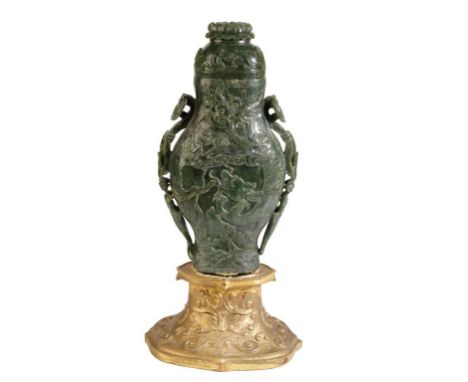 CARVED SPINACH JADE 'DRAGON' VASE AND COVER, the flattened baluster sides carved with dragons amongst clouds, chasing the fla