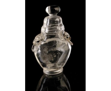 CARVED ROCK CRYSTAL COVERED VASE, the flattened baluster sides with twin mask and loop handles, the domed cover with a knop f