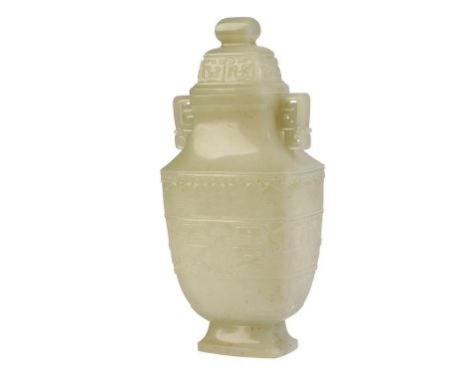 ARCHAIC STYLE WHITE JADE VASE AND COVER, the square form baluster sides carved with bands of taotie masks, scrolls and ruyi's