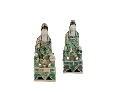 TWO FAMILLE VERTE POTTERY FIGURES OF GUANYIN, KANGXI PERIOD, each modelled as the deity seated on a lotus petal throne flanke