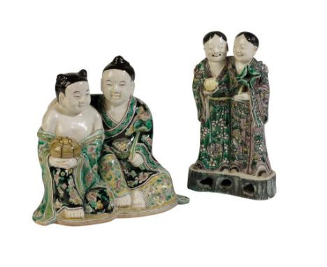 FAMILLE VERTE POTTERY FIGURE GROUP, KANGXI PERIOD, modelled as two standing boys, on a naturalistic base, 18cm high; together