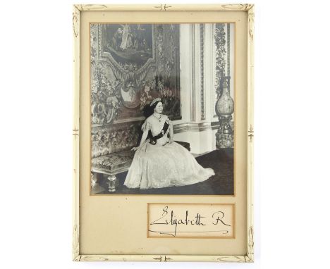 Elizabeth (The Queen Mother, 1900-2002). Portrait silver gelatin vintage photo showing the Queen Mother  seated in a long dre