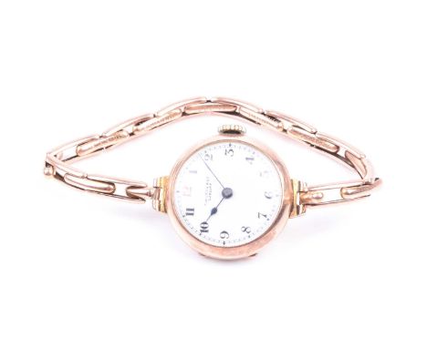 An early 20th century 9ct yellow gold ladies wristwatch, the white enamel Arabic numeral dial marked T.W. Long &amp; Co. Card
