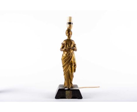 A Victorian gilt-bronzed table lamp, modelled in the form of a classical maiden in long sweeping dress, raised on a slate and