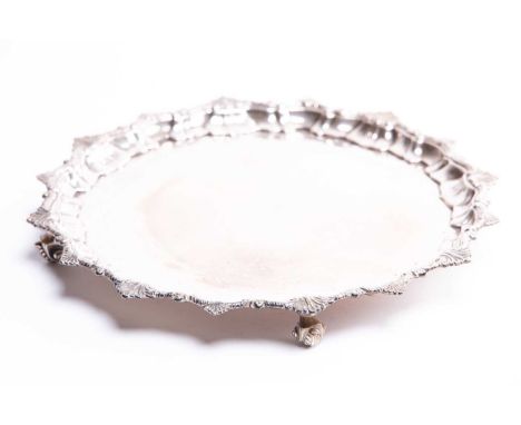 A George V silver salver, London 1913 by George Howson, with piecrust edge on four scroll feet, 25.5 cm diameter, 19.3 ozt.