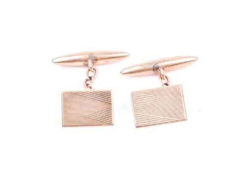 A pair of 9ct yellow gold cufflinks, with rectangular engine-turned plaques, and hollow lozenge fastens.Condition report: 2.7
