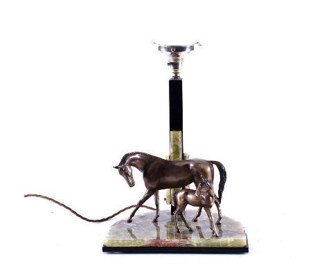 An Art Deco style equestrian-themed table lamp, modelled with a spelter mare and foal on a green onyx base, beneath a square 