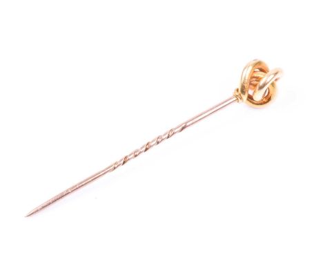 A yellow metal stick pin, of knotted design, the mount engraved 18K, the stick unmarked (likely 9ct rose gold, 6.1 cm long.Co