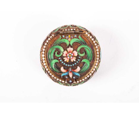 A Russian silver gilt and enamel pill box, circular with flat hinged cover and rounded thumbpiece; decorated throughout with 