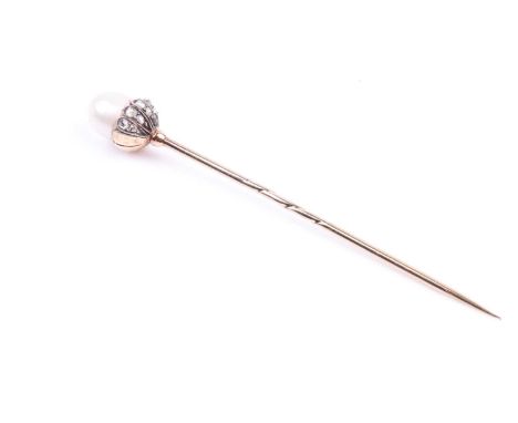A gentleman's tie pin, set with a natural freshwater pearl, in a diamond mount, yellow metal pin unmarked, 6.8 cm long, in an