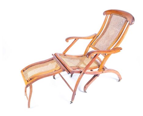 A Victorian folding steamer chair, circa 1870, with bergere back, seat and foot rest, on white ceramic casters, 90cm high, 12