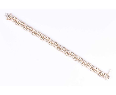 A yellow metal and diamond double line braceletthe articulated segments inset with round brilliant-cut diamonds of approximat
