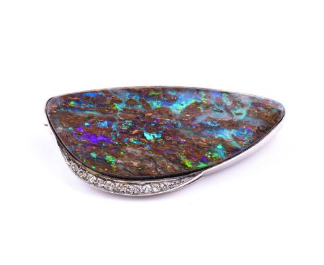 A diamond and boulder opal brooch, set with an elongated boulder opal, the white metal mount set to one side with eleven smal