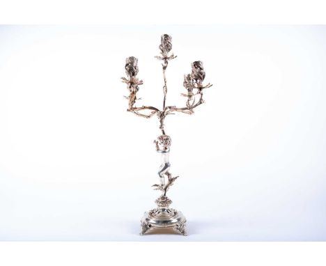 An Italian silver five-light candelabrum, stamped 800, five leaf-capped scroll arms each supporting a leaf-capped urn capital