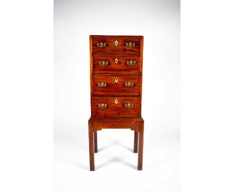 A small George III mahogany chest on stand, the plain caddy top with moulded rim, over four graduated drawers with brass hand