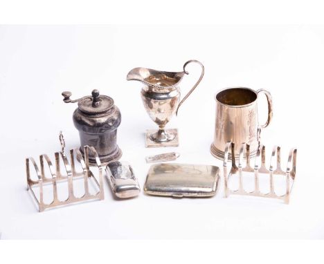 A mixed group of small silver items to include a pair of toast racks, Birmingham 1928 by Adie Brothers, a Victorian helmet sh