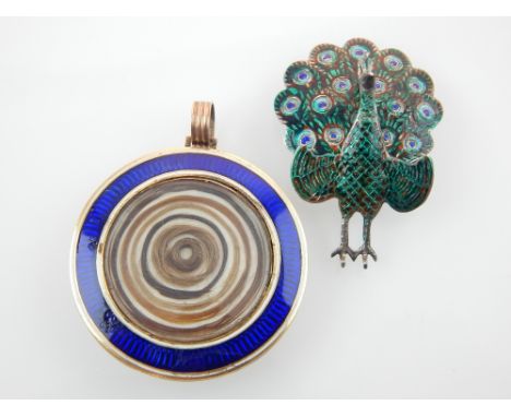 Sterling silver and enamelled peacock brooch, and a gold and blue enamelled disc pendant mourning locket, (2)