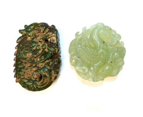 Chinese green pierced jade pendant of a flame breathing dragon, approx. 5cm dia, and a spinach green jade pendant of a scaly 