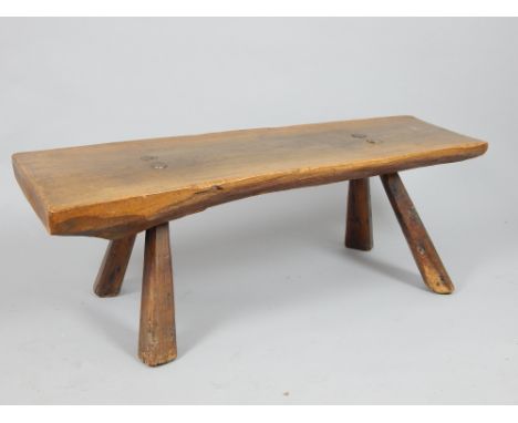 Primitive oak trunk section low table on four chip carved feet, 150 cm L