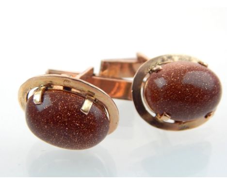 Pair of cufflinks, claw set cabochon stone within yellow metal frames stamped with purity marks, 11.3g