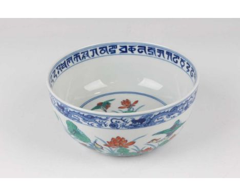 A Chinese doucai porcelain circular bowl, mark of Daoguang but 20th century or later, the exterior painted with a continuous 