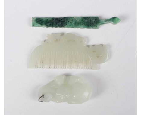 A Chinese pale celadon jade comb of curved form with carved chilong surmount and handle, length 9cm, together with a pale cel