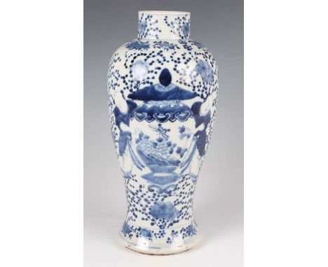A Chinese blue and white porcelain vase, mark of Kangxi but late 19th century, of baluster form, painted with opposing pairs 