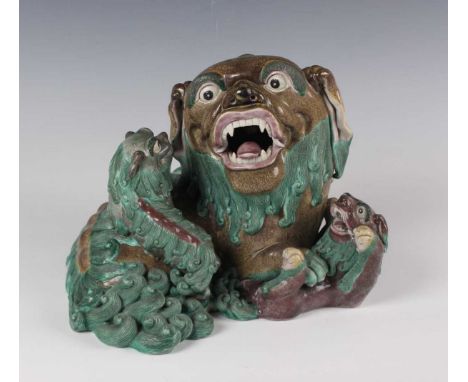 A Chinese porcelain figure group of Buddhistic lions, late 19th century, finely modelled as a recumbent Buddhistic lion and t
