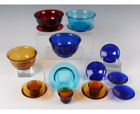 A collection of Chinese Peking glass, late Qing dynasty, comprising three translucent amber wine cups and two saucers, height
