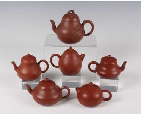 A group of Chinese Yixing stoneware teapots and covers, 19th/20th century, including one of baluster form with naturalistic h