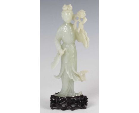 A Chinese carved pale celadon jade figure of a maiden, 20th century, modelled holding a flower stem and fan, height 16.7cm, w