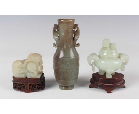 A Chinese archaistic jade vase, Qing dynasty, the swollen cylindrical body and slightly flared narrow neck carved in low reli