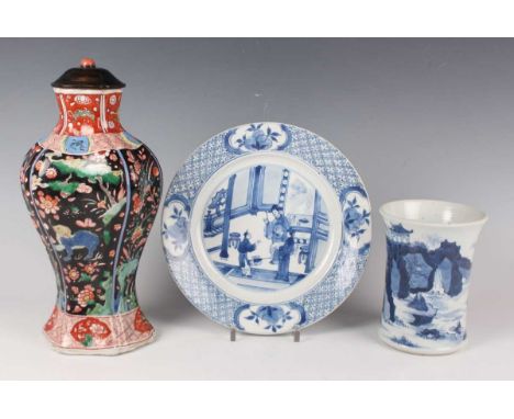 A Chinese famille verte black ground porcelain vase, Kangxi period, of lobed hexagonal baluster form, painted with Buddhistic
