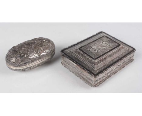 A South-east Asian white metal filigree rectangular box, the hinged lid and sides with lattice and scroll panels, length 8.8c