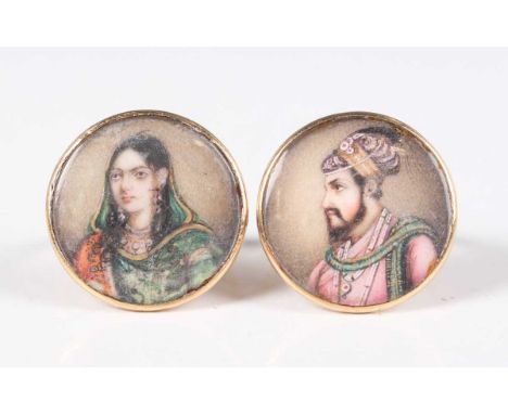 A pair of gold rings, each inset with a glazed circular miniature portrait of the Mughal Emperor Shah Jahan and the Empress C