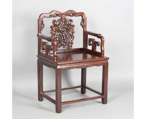 A Chinese hardwood armchair, late 19th/early 20th century, the shaped top rail above a carved and pierced bat, shou medallion
