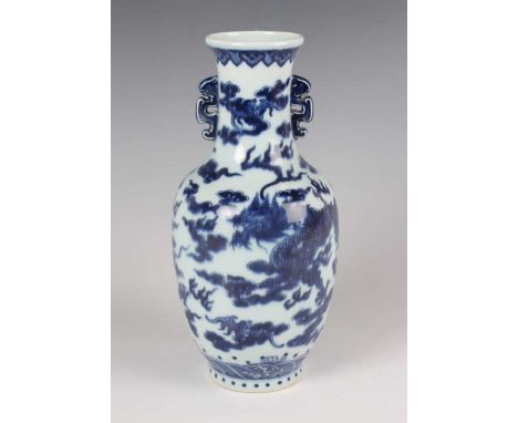 A Chinese blue and white porcelain vase, mark of Jiaqing but modern, the shouldered tapering body and flared neck painted wit