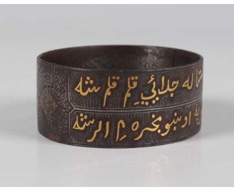 A Qajar gold damascened steel hinged bangle, late 19th/early 20th century, one side decorated with two lines of Islamic scrip