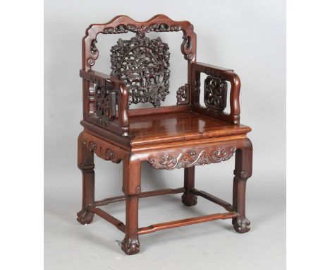 A Chinese hardwood armchair, late 19th/early 20th century, the shaped top rail above a carved and pierced circular panel spla